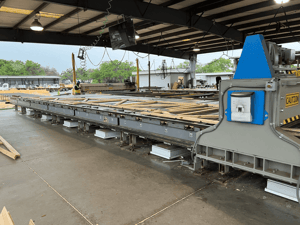 Long-Wood-Panel-Moving-Through-Machine-min